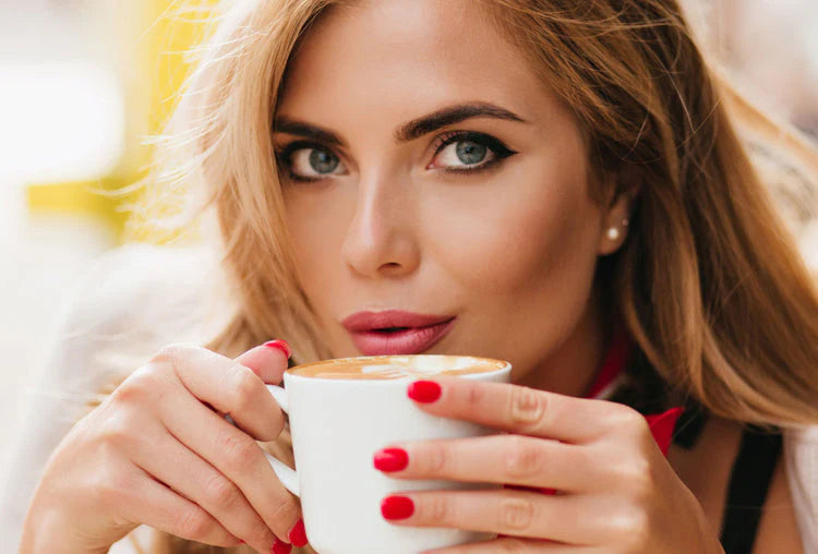 Woman holding a coffee cup with a blurred background