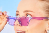 woman with freshly waxed eyebrows looking over her sunglasses