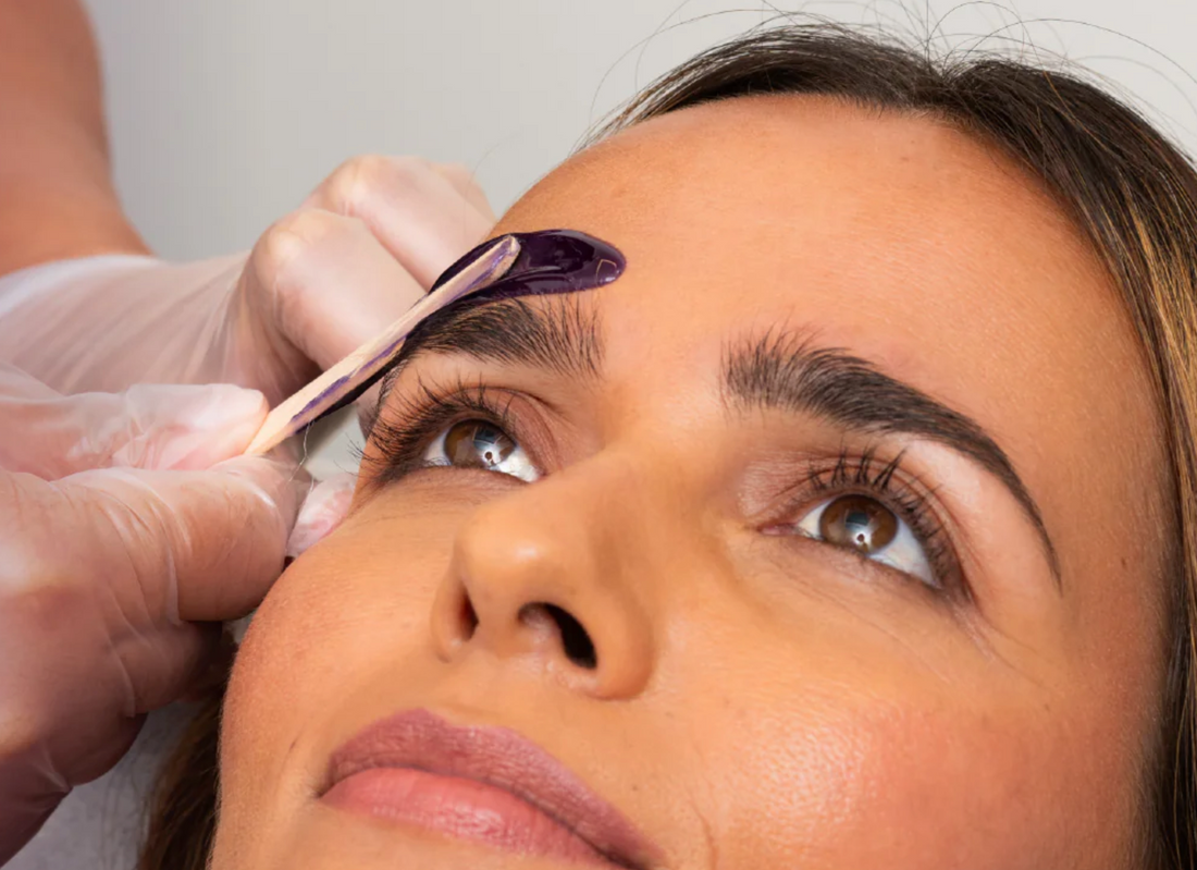 Woman getting her eyebrow waxed