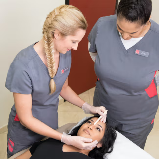 two waxing specialists preparing a facial