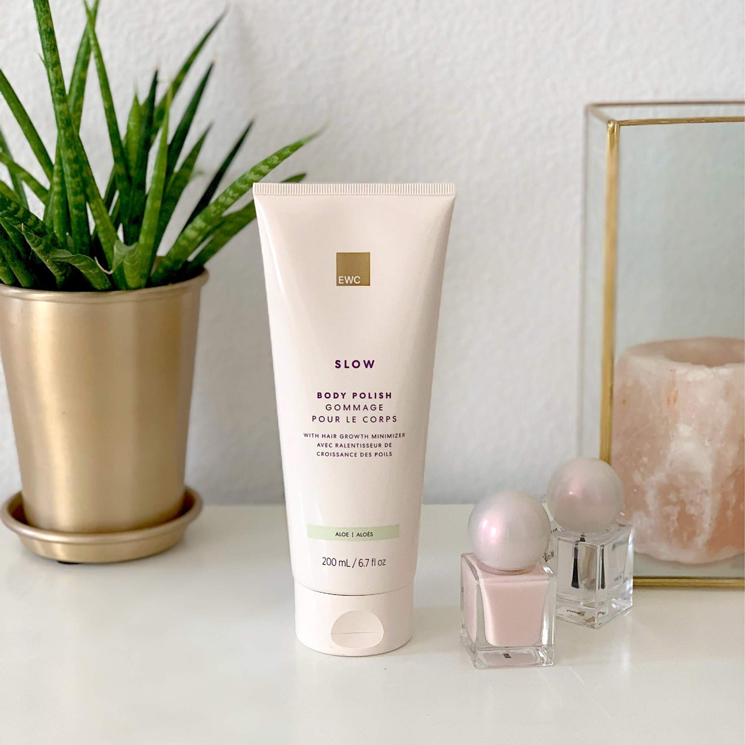 EWC Slow Aloe Body Polish resting over a counter