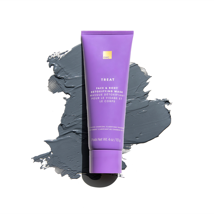 A tube of Face & Body Detoxifying Mask resting on top of a smudge of charcoal mask.