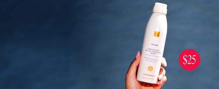 Hand holding a bottle of the new EWC SPF 50 sunscreen with a blue background, $25.