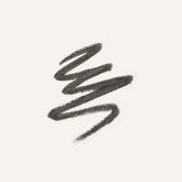 A textured swipe of dark brown eyebrow pencil on a solid off-white background.