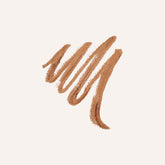 A textured swipe of light brown eyebrow pencil on a solid off-white background.